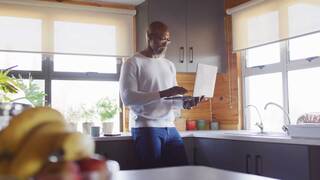 Person Looking at computer in kitchen