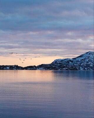 landscape image of lake and mountains at sunset