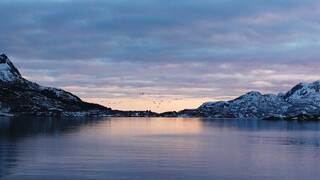 landscape image of lake and mountains at sunset