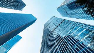 upwards angle of skyscrapers with blue skies