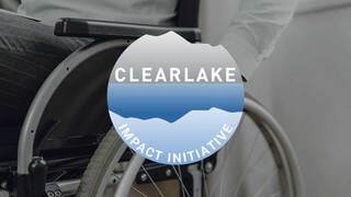 person in green shirt with American flag badge and hand on their heart