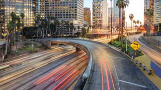 winding highways and city lights at sunset