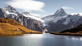 mountains with snowcaps on the water