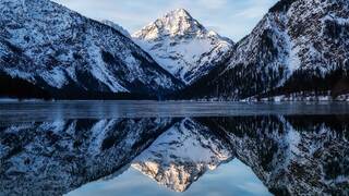 snowy mountains on a lake